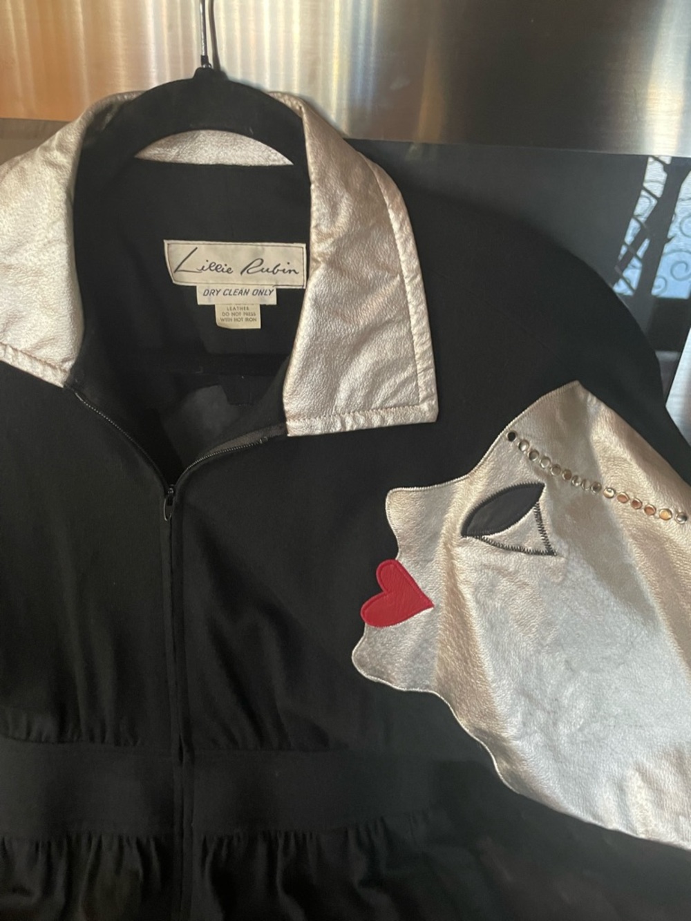 Lillie Rubin Black jumpsuit with Silver leather woman’s face Red leather lips.